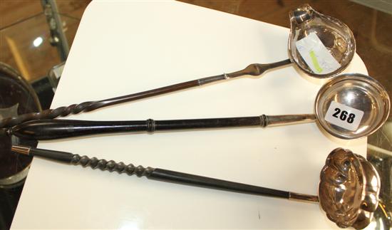 Silver ladles with ebonised handles and one other